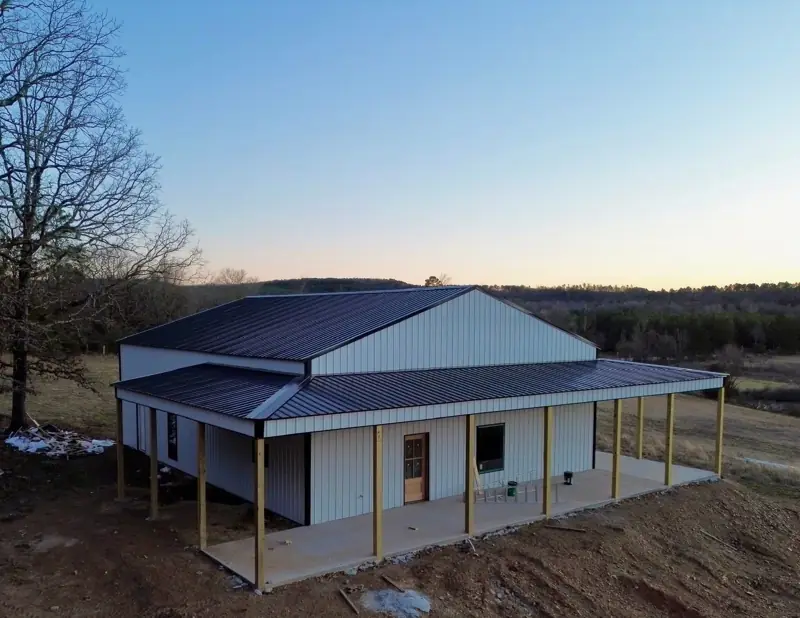 Aerial rear view of the barndominium at dusk