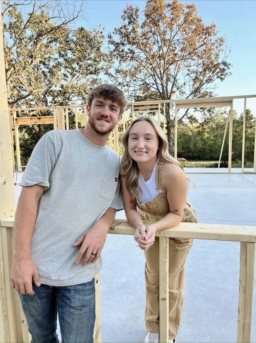 Carter and Madison Henson, owners of C&M Innovations, standing on a freshly framed home site