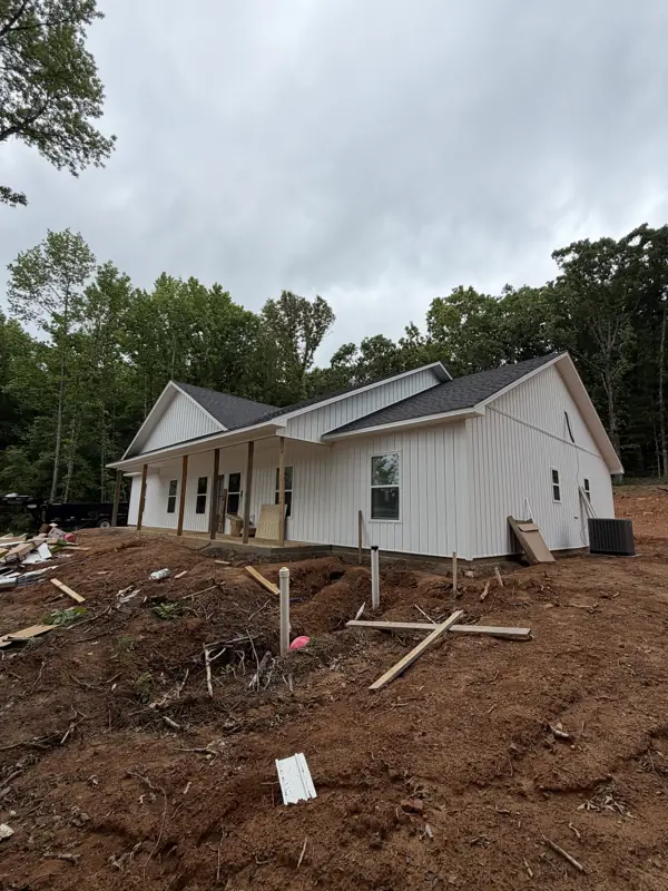 Side view of the farmhouse during final grading