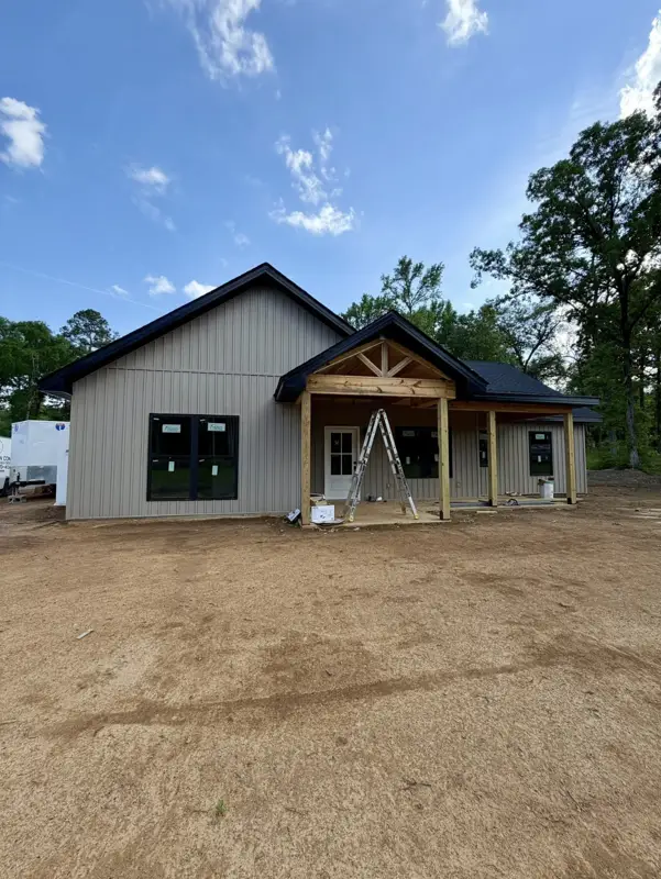 Finished tan gable home with a timber-frame porch