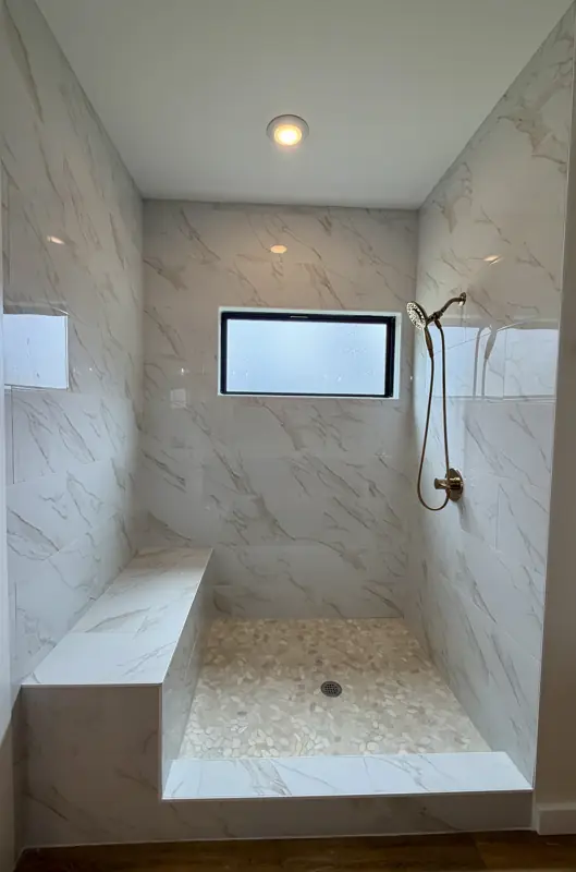 Walk-in tiled shower with built-in bench