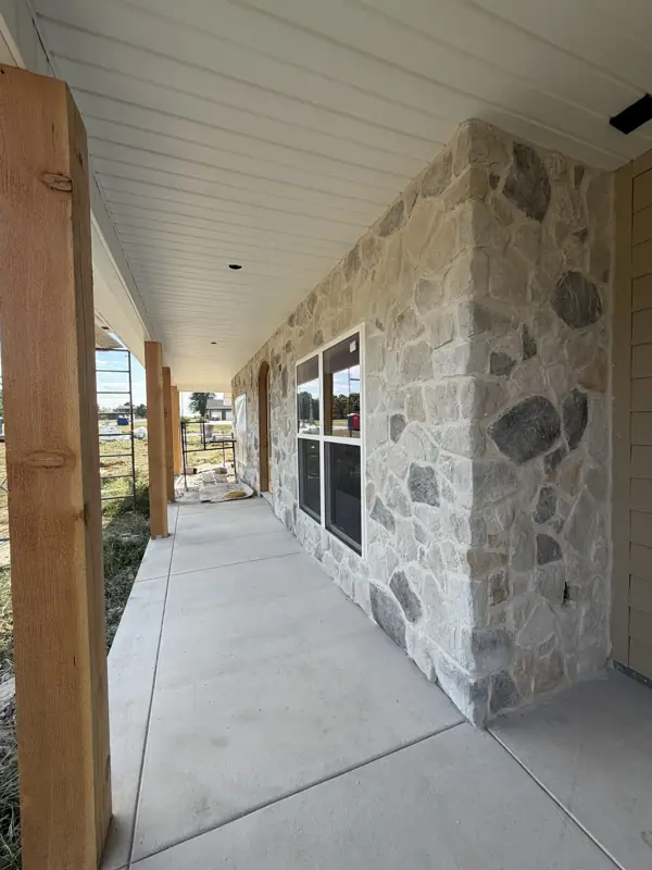 Covered porch with stone columns